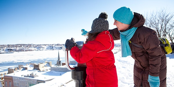 A young girl and lady looking out at the view of the St. Lawrence River.